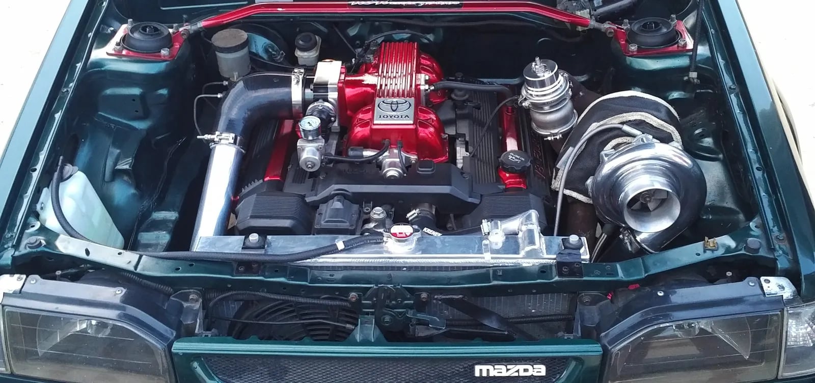 Turbocharged 1UZ V8 in a Mazda engine bay, running Spitronics